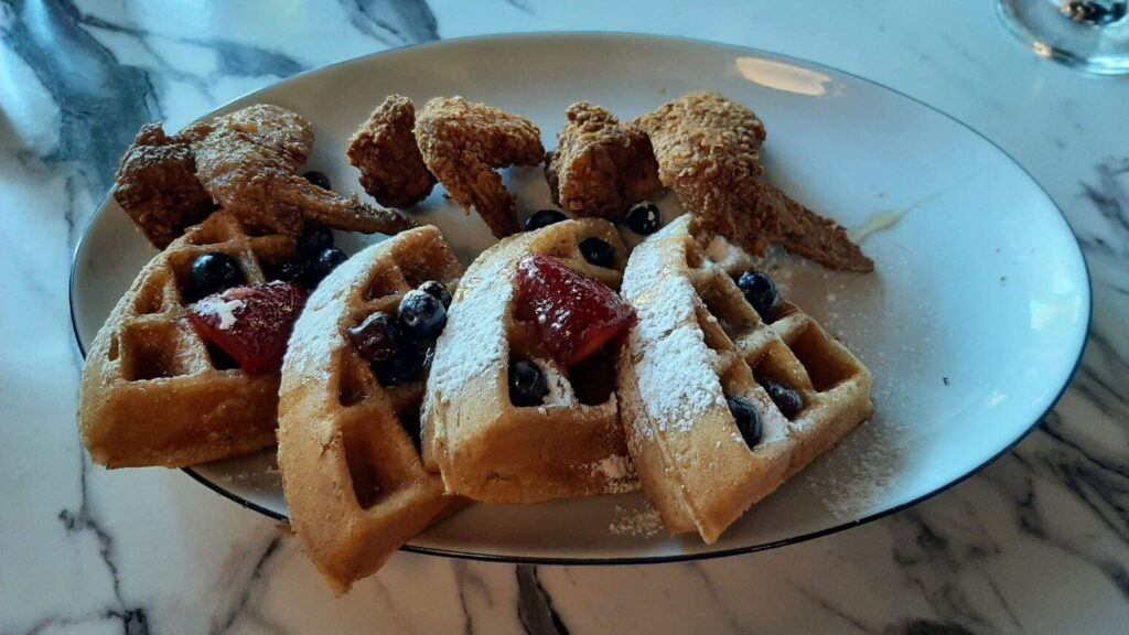 Chicken and waffles with berries at Breakfast at Barney's