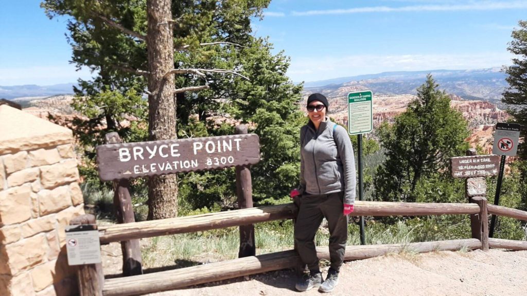 Person by Bryce Point Sign at the start of Hat Shop Trail