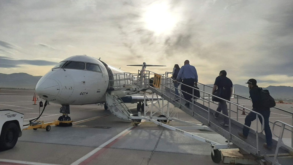Delta airplane with a passenger boarding ramp