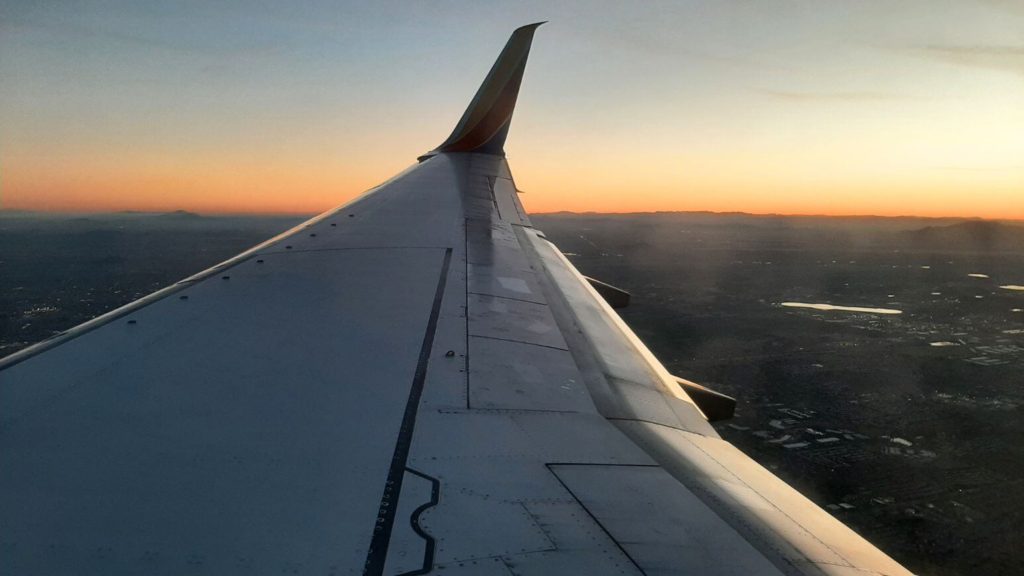 Airplane wing at sunset