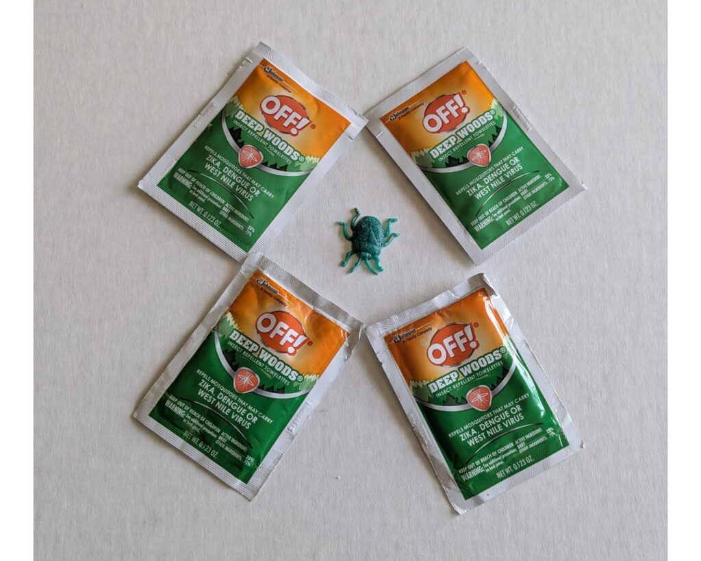 4 individual OFF! Deep Woods Mosquito and Insect Repellent Wipes with a plastic bug in the middle