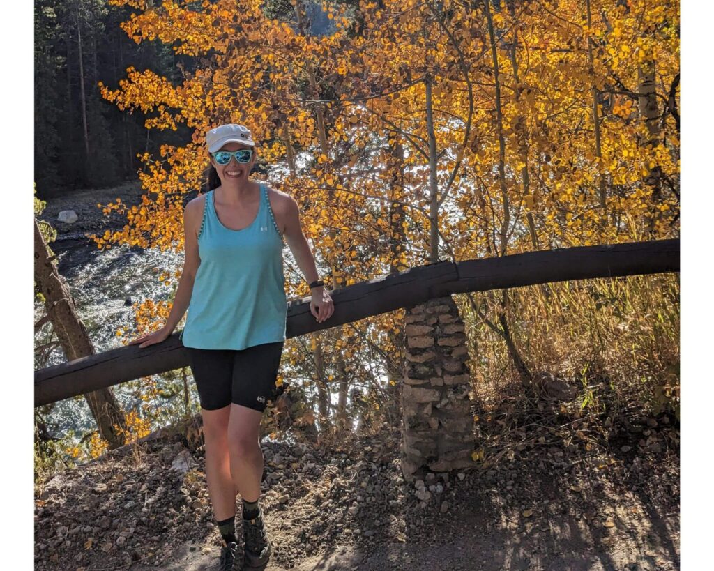 Teal tank top against orange leaves at Yellowstone NP