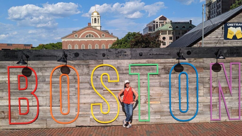 Boston sign with Faneuil Hall in the background 