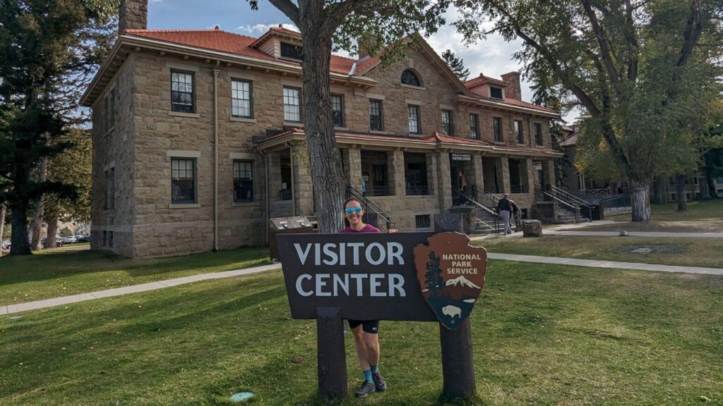 Standing by the sign outside of Albright Visitor Center