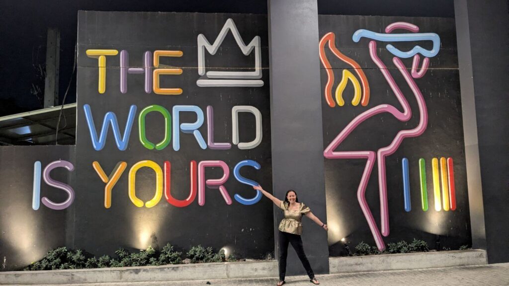 The Fearless Foreigner Travel Planner in front of "the World is Yours" art