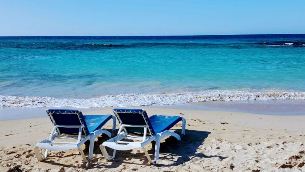Travel planner vs Travel agent: Caribbean beach with lounge chairs